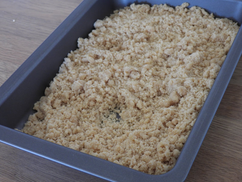 Crumble mix added to tray for baking