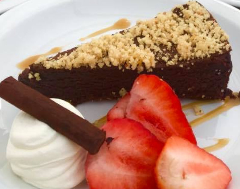 Dark Chocolate Truffle Torte served with Strawberries and Cream